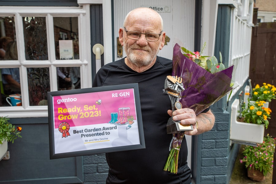Mr Devine with his certificate and prizes